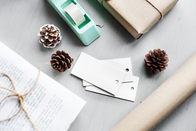 Wrapped Present Gift Box with Pine Cone on Wooden Background