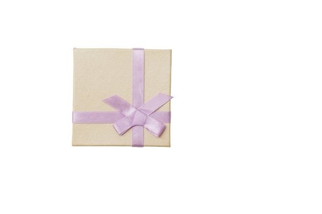 Free photo wrapped vintage gift box with red ribbon bow, isolated on white.