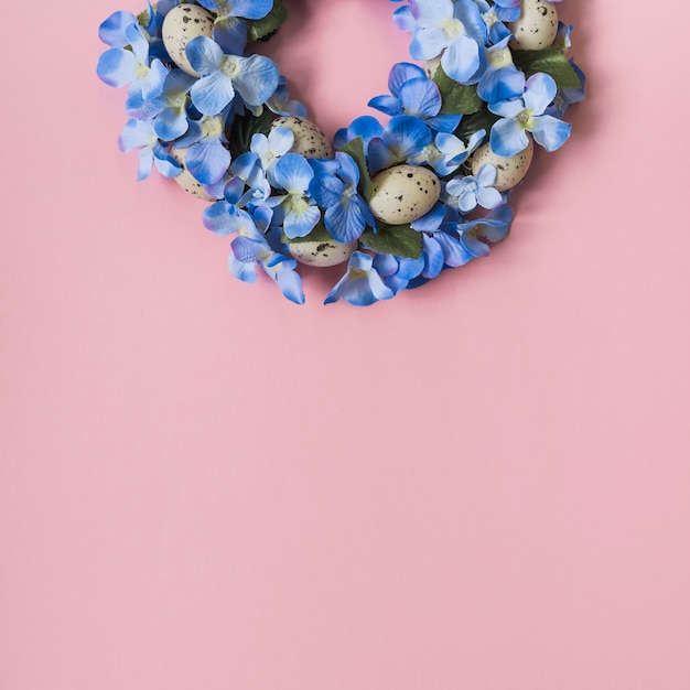 Wreath made from bright flowers and eggs