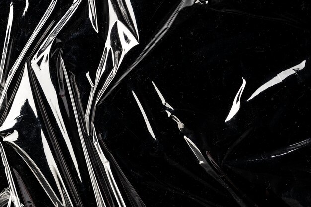 wrinkled plastic wrap texture on a black background wallpaper
