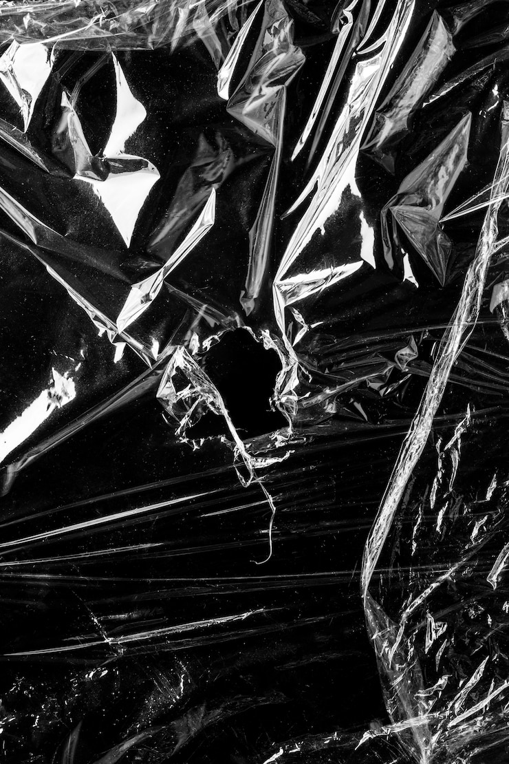 Free Photo wrinkled plastic wrap texture on a black background