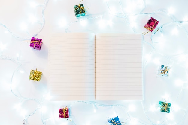 Free photo writing book between gifts and fairy lights