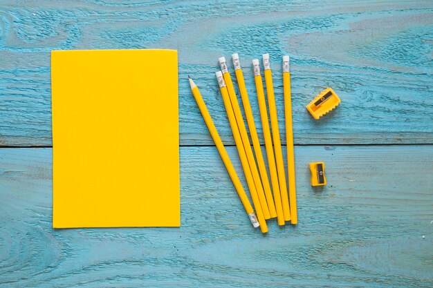 Writing pencils laid near piece of paper