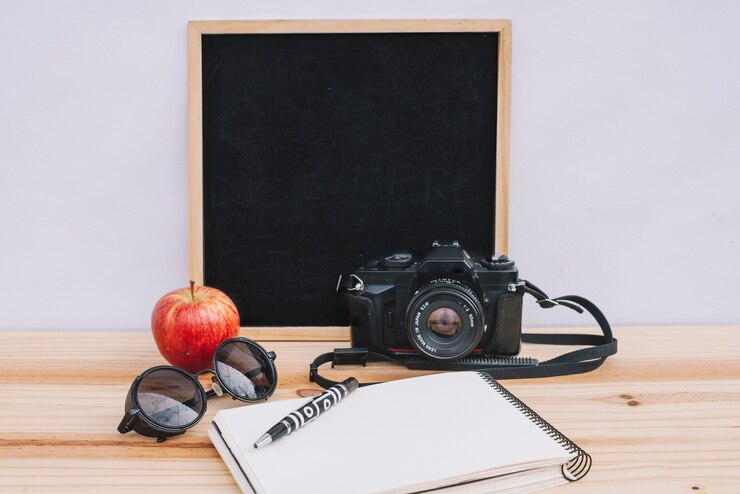 Free Photo writing surfaces near apple and camera