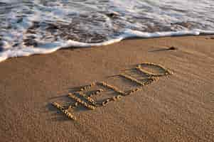 Free photo writing words in the sand