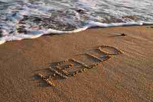 Free photo writing words in the sand