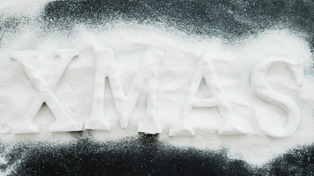 Xmas inscription between decorative snow 