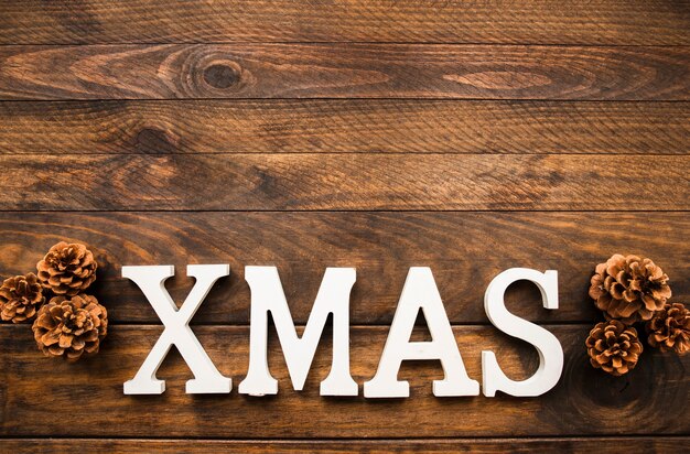 Xmas inscription near snags on wooden board