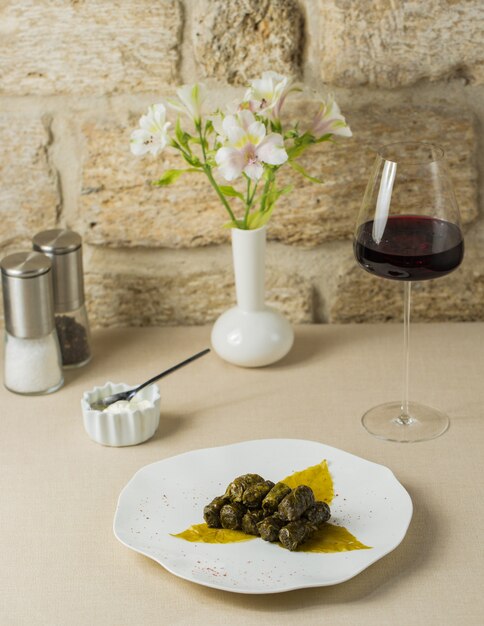 Yarpaq dolmasi, grape leaf dolma with a glass of wine