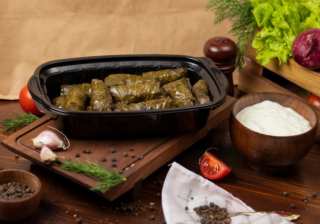 Yarpaq dolmasi, yaprak sarmasi, green grape leaves stuffed with meat takeaway   