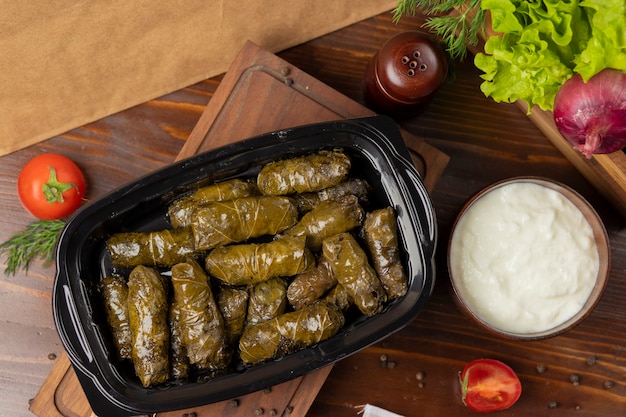 Yarpaq dolmasi, yaprak sarmasi, green grape leaves stuffed with meat takeaway 