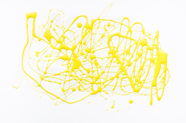 Free Photo yellow acrylic splash on white canvas