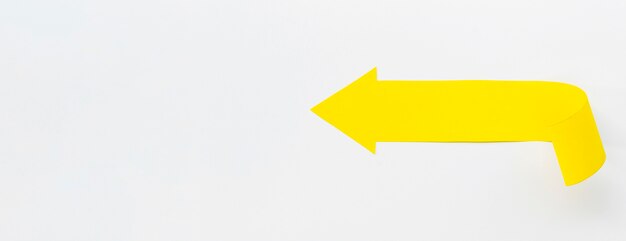 Yellow arrow pointing left with copy space