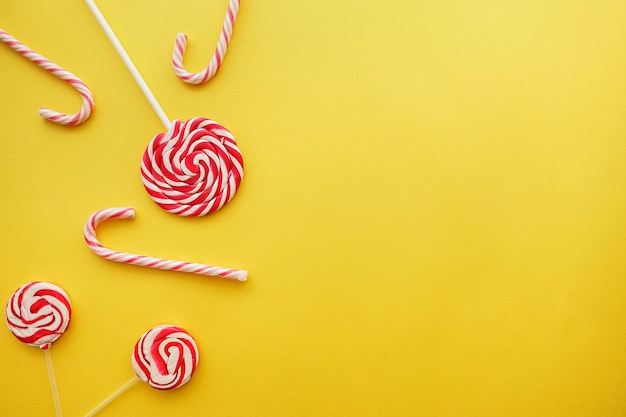 Yellow background with candy canes and lollipops