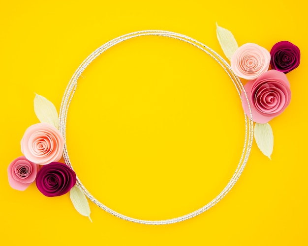 Free photo yellow background with cute paper flowers