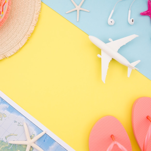 Yellow background with hat, map and sandals