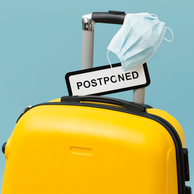 Yellow baggage with postponed sign