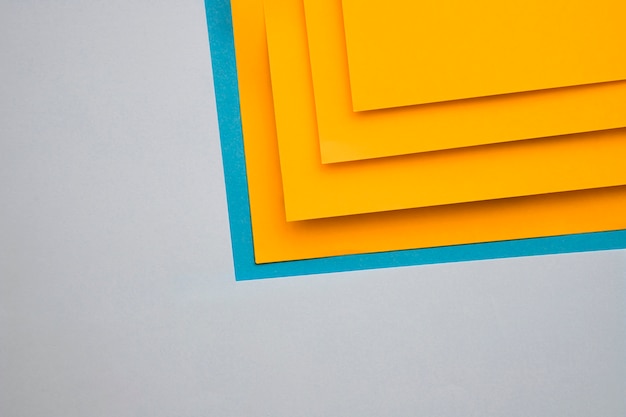 Yellow and blue craftpapers on grey background