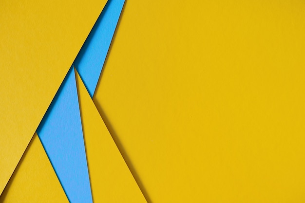 Yellow and blue geometric composition paperboard background with copyspace