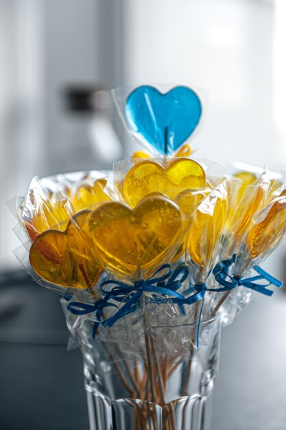 Yellow and blue heart shaped lollipops with caramel