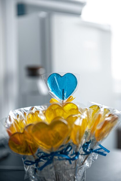 Yellow and blue heart shaped lollipops with caramel