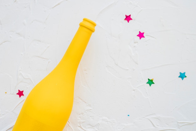 Yellow bottle with star spangles on table