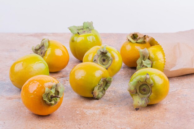 Yellow bright plum dates on pink table.