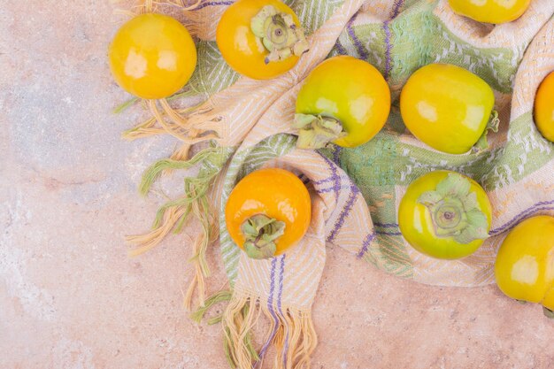 Yellow bright plum dates on pink table.