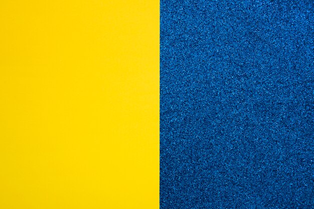 Yellow cardboard paper on blue carpet