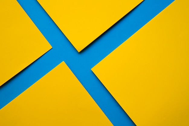 Yellow cardboard papers on blue surface