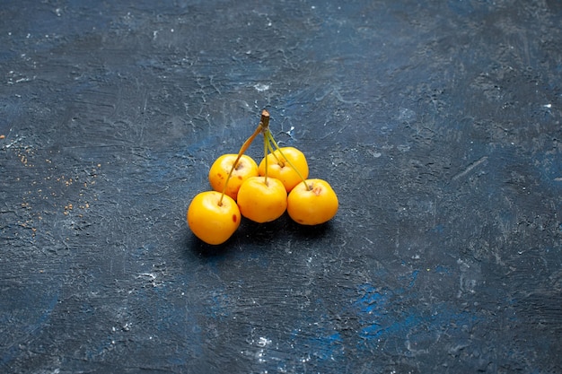 yellow cherries isolated on dark desk