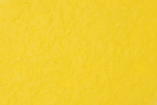 黄色い粘土のテクスチャ背景カラフルな手作りの創造的な芸術の抽象的なスタイル