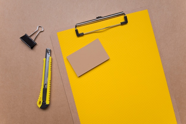 Free photo yellow clipboard with stationery business visiting card