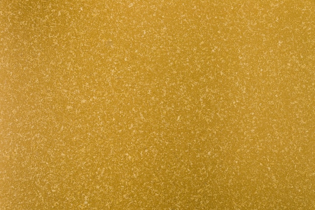 Yellow concrete surface with rough appearance