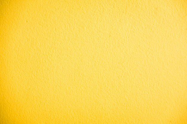 黄色のコンクリートの壁のテクスチャ