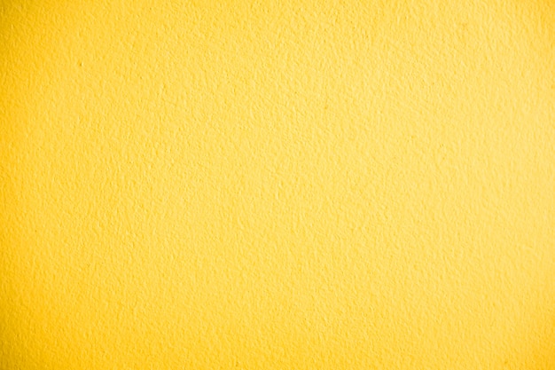 黄色のコンクリートの壁のテクスチャ