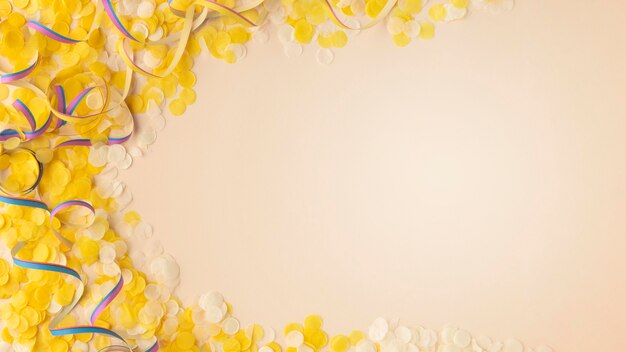 Yellow confetti and ribbons copy space