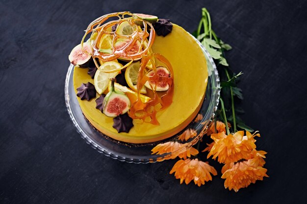 Yellow creme cake with different fruits. close up image