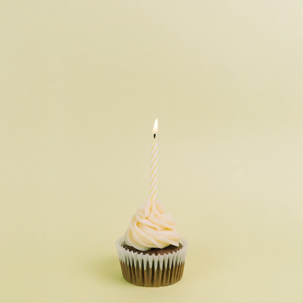 Yellow cupcake with candle