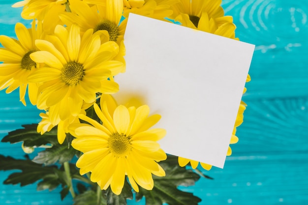 Yellow daisies with blank note