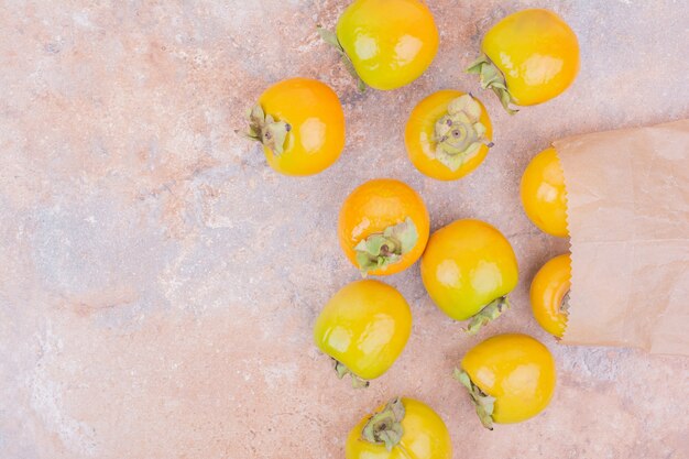 Free photo yellow date plums isolated on a pink surface