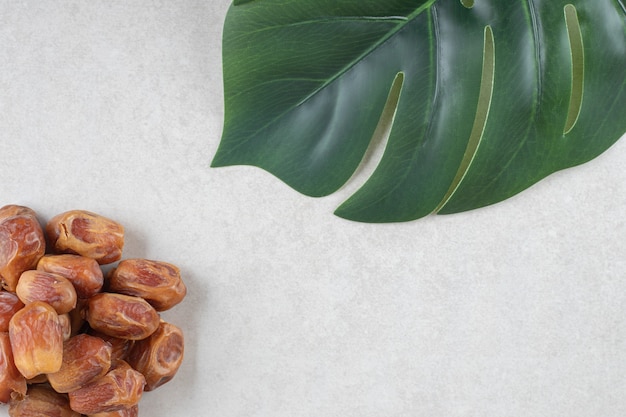 Yellow dry dates isolated on concrete.