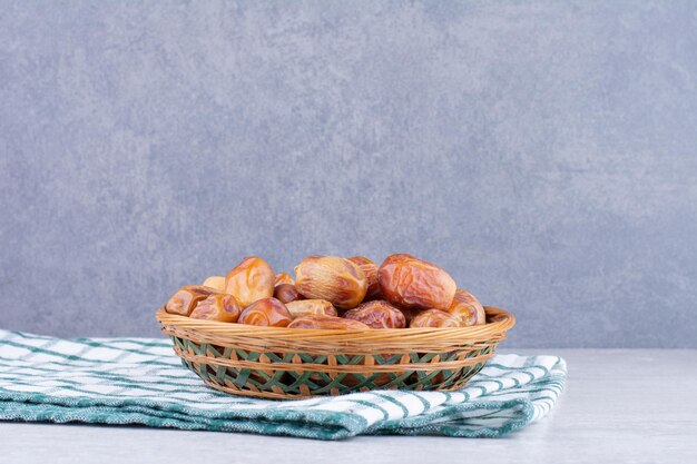 Yellow dry dates on a wooden platter. High quality photo