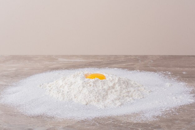 Yellow egg yolk on white flour.