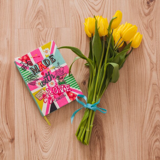 Yellow flowers next to a colorful book