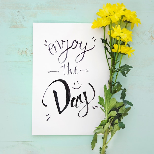 Yellow flowers near paper with writing