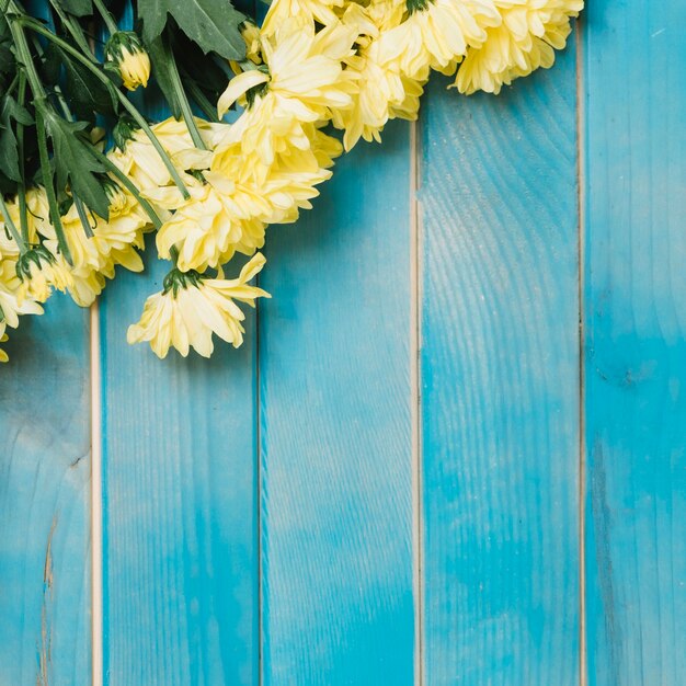 Yellow flowers on wooden table