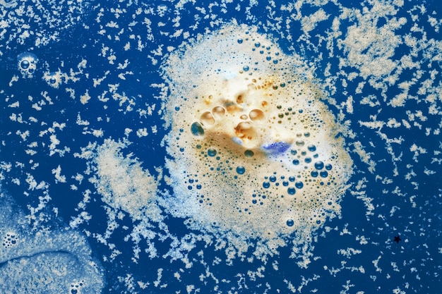 Yellow foam on blue water