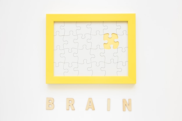 Yellow frame with missing jigsaw piece near brain word