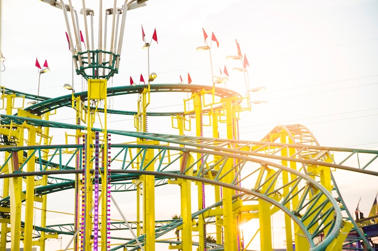 Free Photo yellow and green colored roller coaster ride
